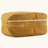 Patagonia black hole 6 litre cube bag in mustard yellow showing the main zip running underneath