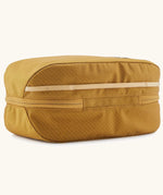 Patagonia black hole 6 litre cube bag in mustard yellow showing the main zip running underneath