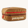 Patagonia black hole 6 litre cube bag in talon gold available at Babipur. A 100% recycled material cube bag in dark yellow with dark red detail. Features 1 main zip compartment with a light blue brand text on the top and a brand patch stitched on the side