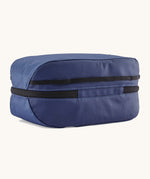 The back of the Patagonia black hole 6 litre cube bag in current blue. showing the main zip compartment running around the bag