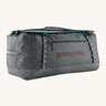 Patagonia black hole 100L duffel bag in noble grey available at Babipur. A dark grey bag with green trim and brown branding on the side. Features shoulders straps and a handle on the top for easy carrying.