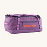Patagonia black hole 40l duffel bag in brisk purple available at Babipur. A bright purple bag with orange branding on the side. Features shoulders straps and a handle on the top for easy carrying.