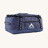 Patagonia black hole 40l duffel bag in current blue available at Babipur. A blue bag with black trim and a mountain graphic on the side. Features shoulders straps and a handle on the top for easy carrying.