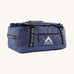 Patagonia black hole 40l duffel bag in current blue available at Babipur. A blue bag with black trim and a mountain graphic on the side. Features shoulders straps and a handle on the top for easy carrying.