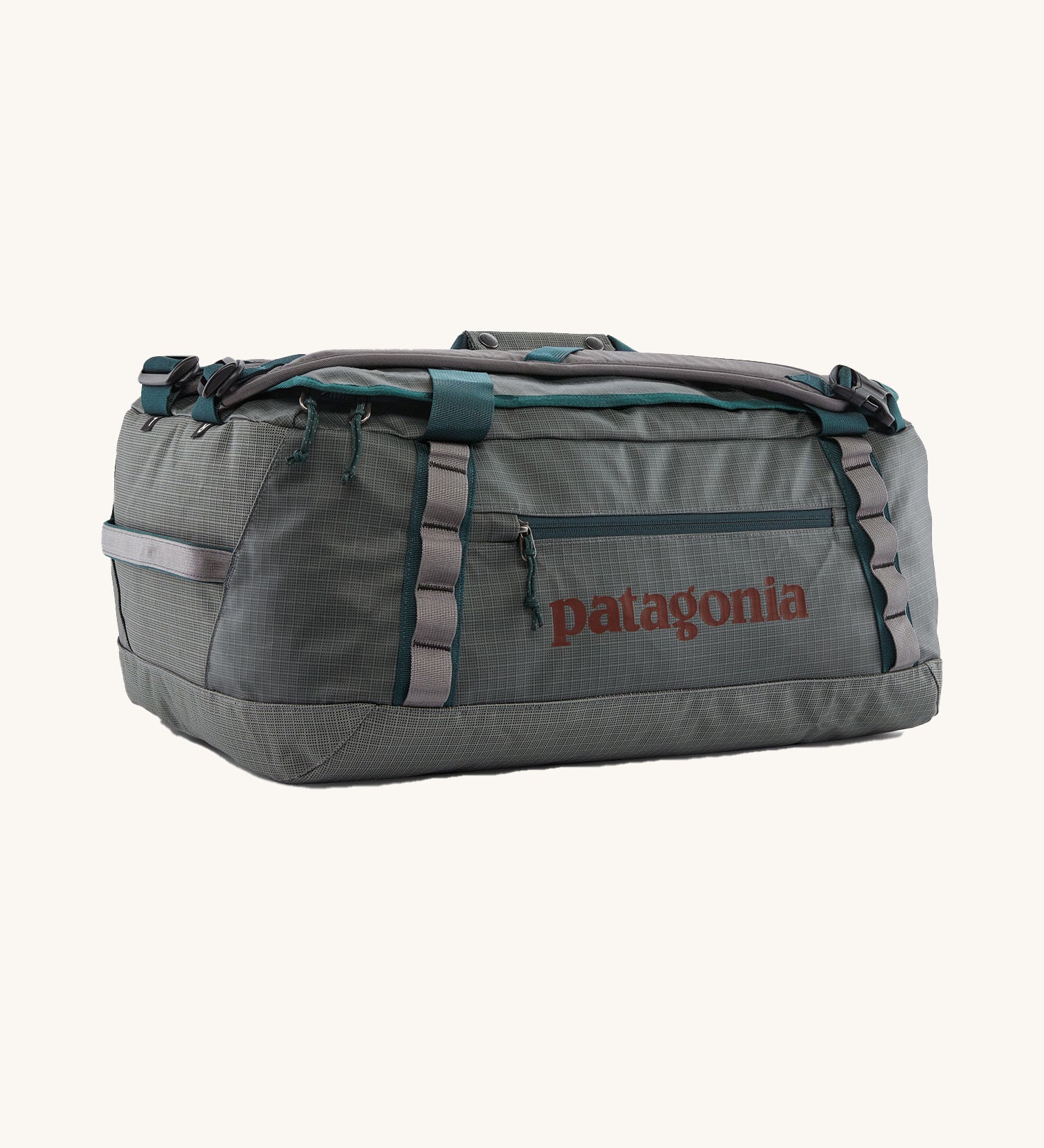 Patagonia black hole 40l duffel bag in noble grey available at Babipur. A dark grey bag with green trim and brown branding on the side. Features shoulders straps and a handle on the top for easy carrying.
