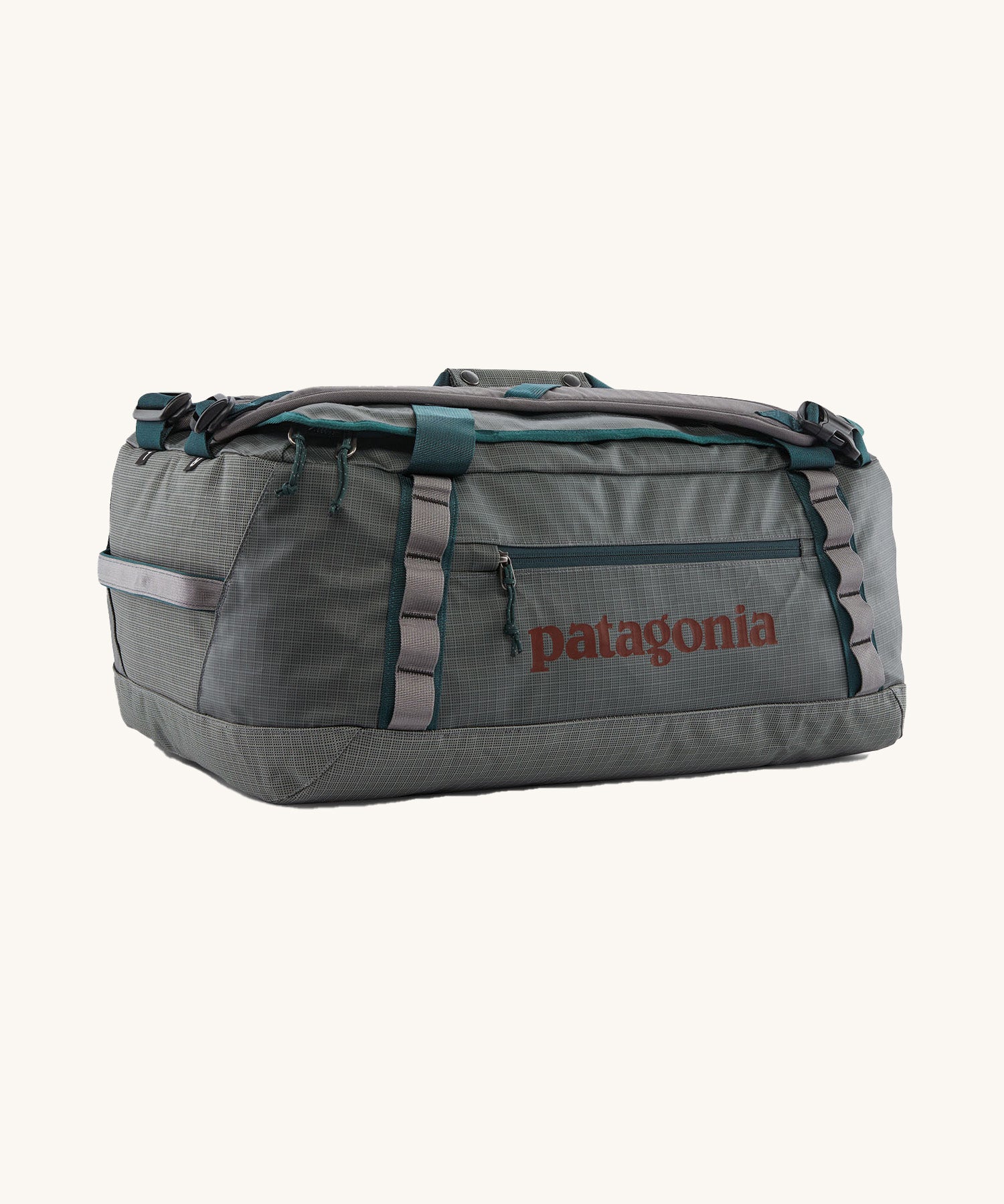Patagonia black hole 40l duffel bag in noble grey available at Babipur. A dark grey bag with green trim and brown branding on the side. Features shoulders straps and a handle on the top for easy carrying.