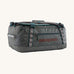 Patagonia black hole 40l duffel bag in noble grey available at Babipur. A dark grey bag with green trim and brown branding on the side. Features shoulders straps and a handle on the top for easy carrying.