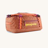 Patagonia black hole 40l duffel bag in bright orange with purple zip details and yellow printed logo on front panel