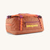 Patagonia black hole 40l duffel bag in bright orange with purple zip details and yellow printed logo on front panel