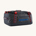 Patagonia black hole 40l duffel bag in smolder blue / amanita red available at Babipur. A dark blue bag with red trim and blue branding on the side. Features shoulders straps and a handle on the top for easy carrying.
