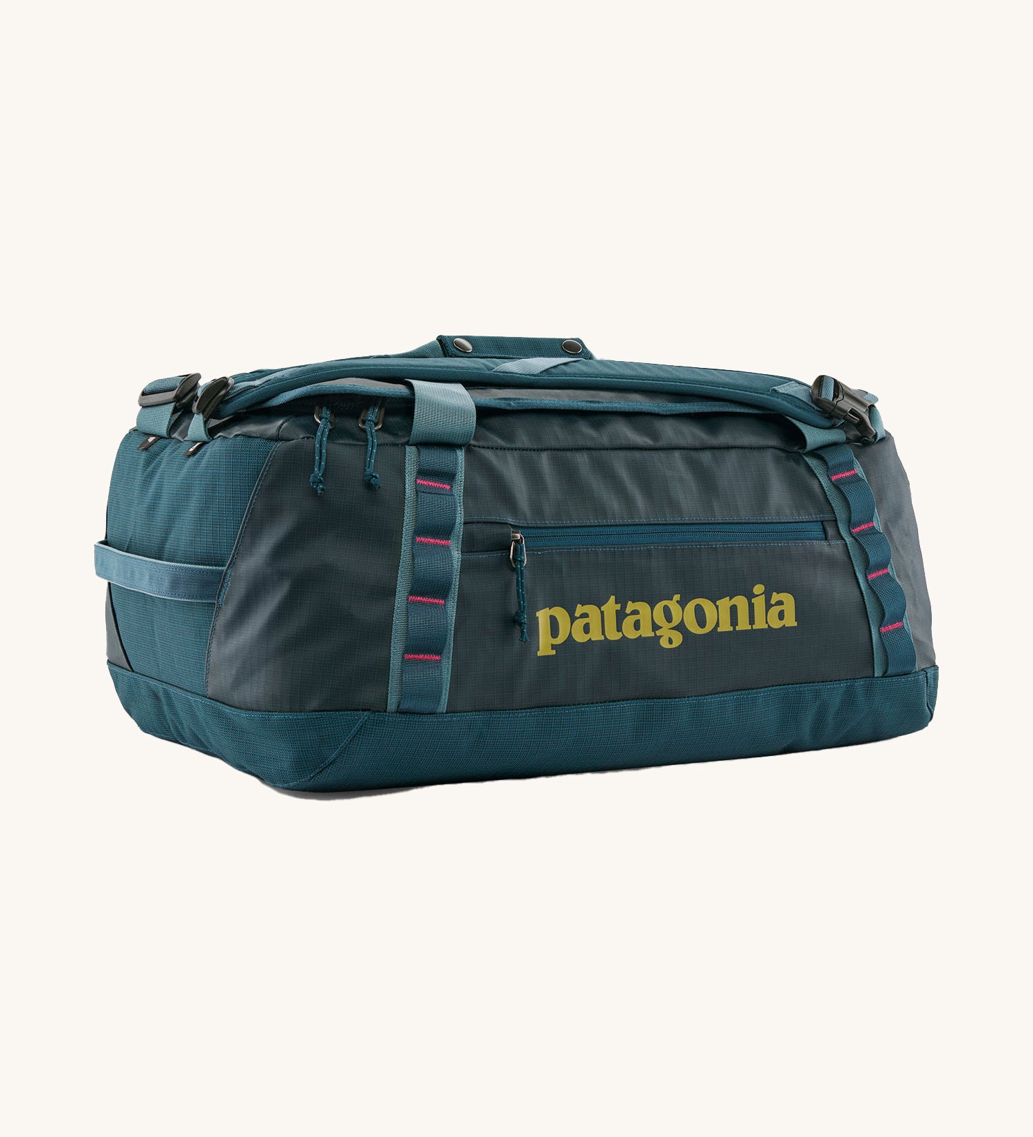 Patagonia black hole 40l duffel bag in tidal teal / luminous pink available at Babipur. A dark teal colour bag with pink trim and a mustard colour branding  on the side. Features shoulders straps and a handle on the top for easy carrying.