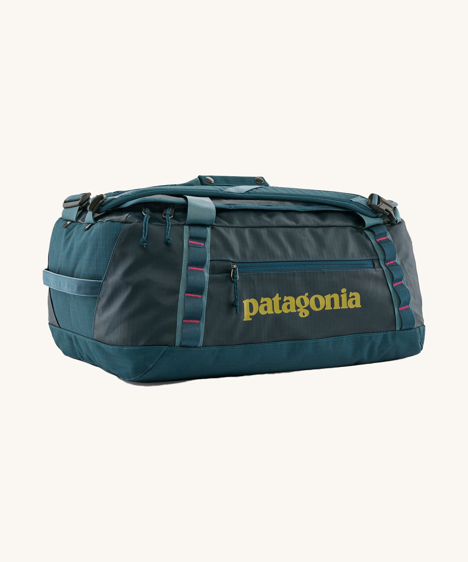 Patagonia black hole 40l duffel bag in tidal teal / luminous pink available at Babipur. A dark teal colour bag with pink trim and a mustard colour branding  on the side. Features shoulders straps and a handle on the top for easy carrying.