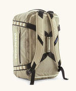 Back of Patagonia black hole 40l duffel bag in light green with matching shoulder straps and extra black carry handles