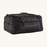 Patagonia black hole 55L duffel bag in black on black available at Babipur. An all black backpack with  shoulders straps and a handle on the top for easy carrying.