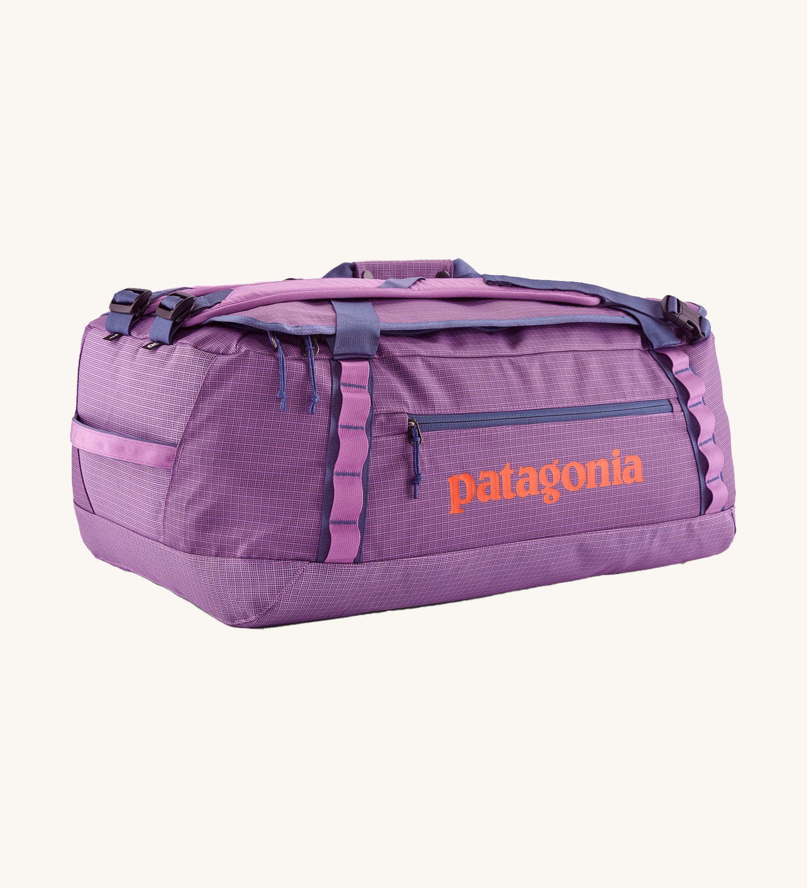 Patagonia black hole 55L duffel bag in brisk purple available at Babipur. A bright purple bag with orange branding on the side. Features shoulders straps and a handle on the top for easy carrying.