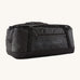 Patagonia black hole 70L duffel bag in black on black available at Babipur. An all black backpack with  shoulders straps and a handle on the top for easy carrying.