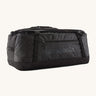 Patagonia black hole 70L duffel bag in black on black available at Babipur. An all black backpack with  shoulders straps and a handle on the top for easy carrying.
