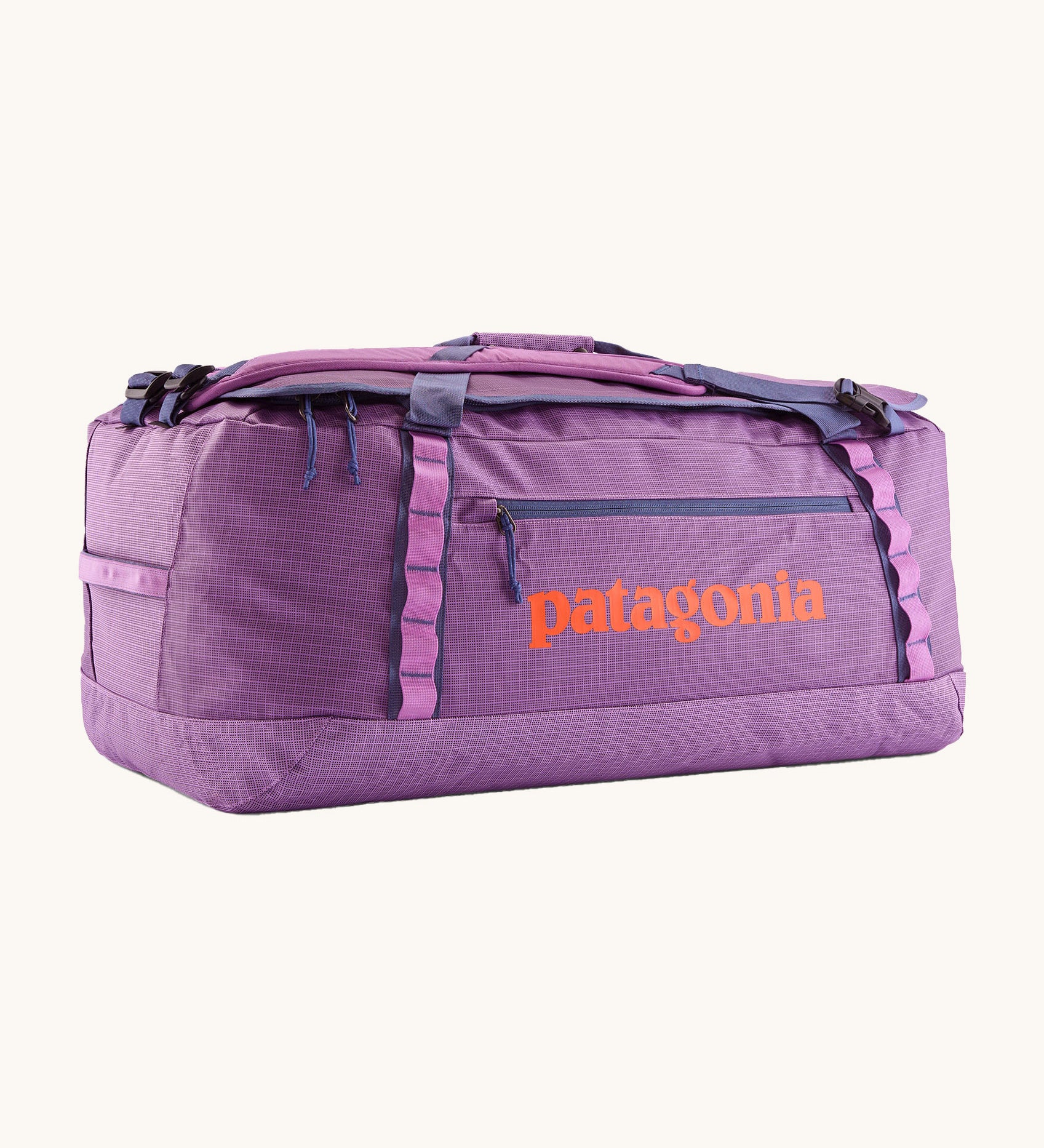 Patagonia black hole 70L duffel bag in brisk purple available at Babipur. A bright purple bag with orange branding on the side. Features shoulders straps and a handle on the top for easy carrying.