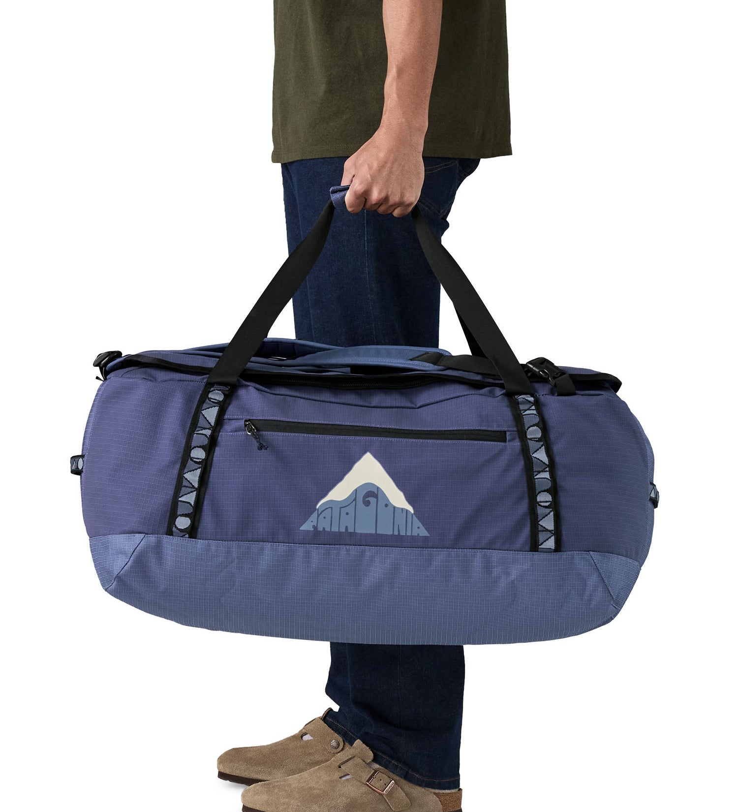A man carrying the Patagonia black hole 70L duffel bag in current blue available at Babipur. 