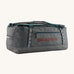 Patagonia black hole 70L duffel bag in noble grey available at Babipur. A dark grey bag with green trim and brown branding on the side. Features shoulders straps and a handle on the top for easy carrying.