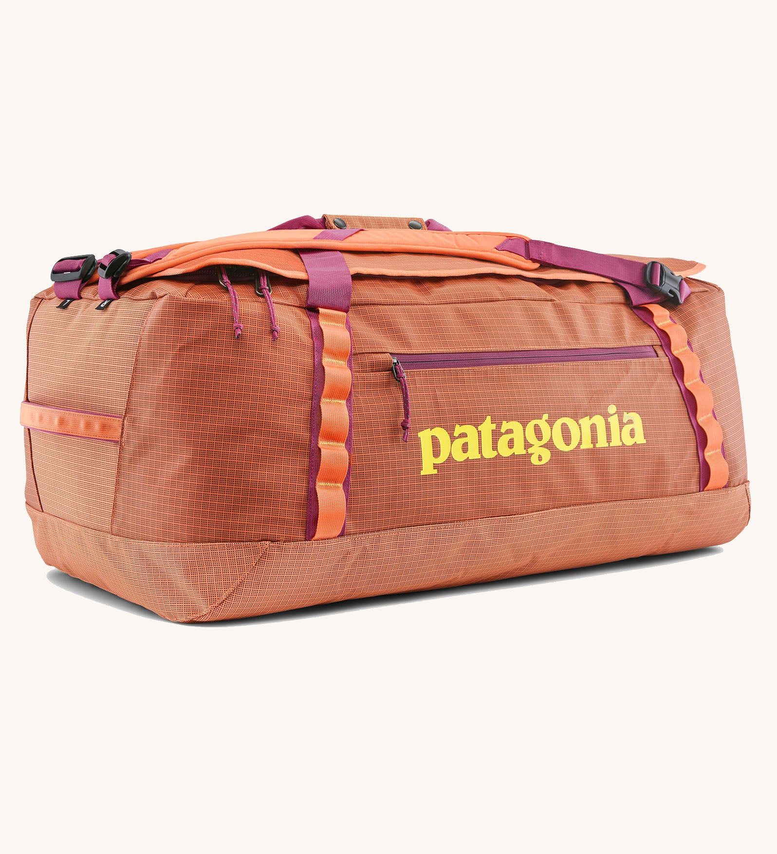 Patagonia black hole 70l duffel bag in bright orange with purple zip details, straps and yellow printed logo on front panel 