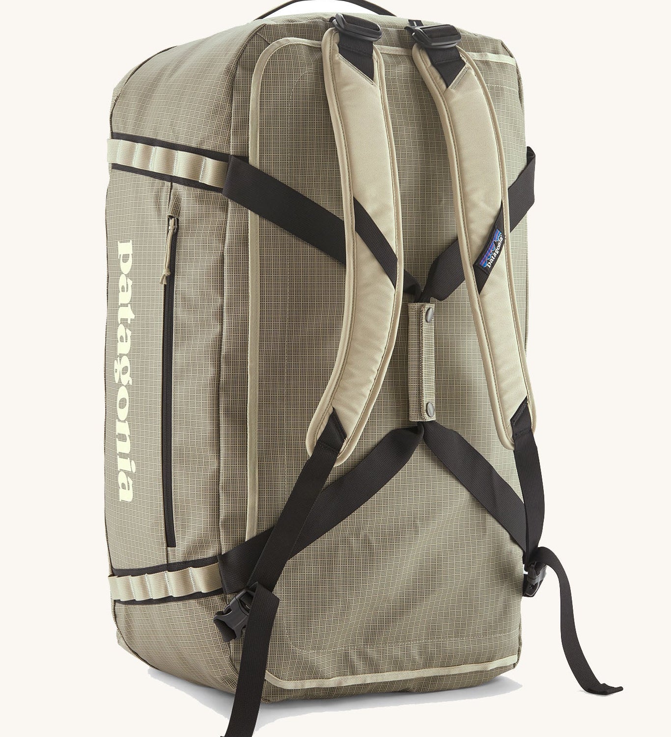Patagonia black hole 70l duffel bag in pale green with matching shoulder straps and extra black carry handles