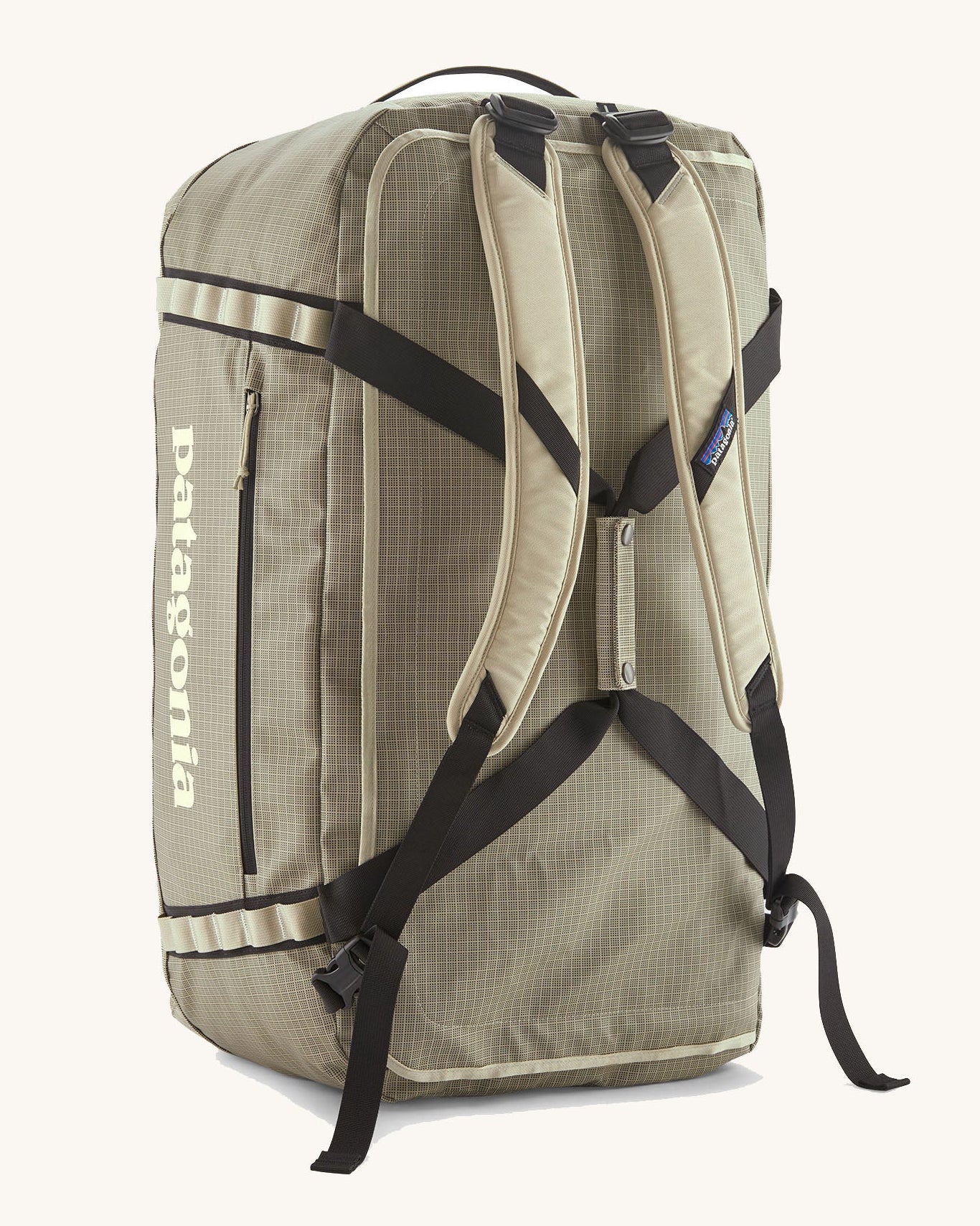 Patagonia black hole 70l duffel bag in pale green with matching shoulder straps and extra black carry handles