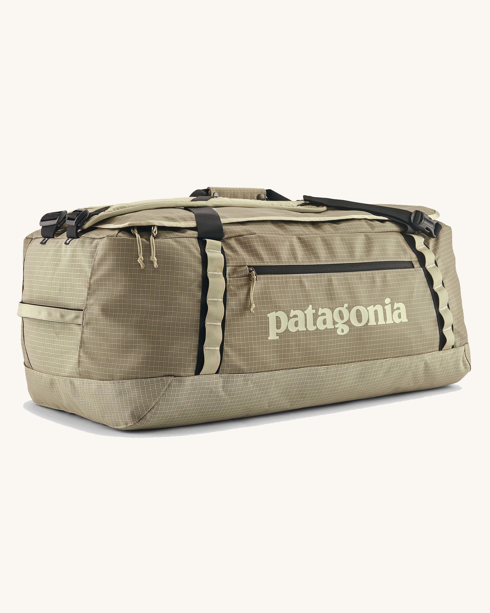 Patagonia black hole 70l duffel bag in pale green with black zip details, straps and cream printed logo on front panel 