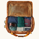 Patagonia Black Hole Duffle 70L in Cinnamon Brown, open showing storage space and mesh zipped pocket. 