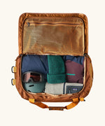 Patagonia Black Hole Duffle 70L in Cinnamon Brown, open showing storage space and mesh zipped pocket. 