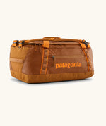Patagonia black hole 40l duffel bag in cinnamon brown with matching zip details, carry straps and orange logo printed on the side