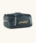 Patagonia black hole 40l duffel bag in deep teal with matching zip details, carry straps and yellow logo printed on the side