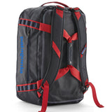 A close up of the Patagonia black hole 40l duffel bag in smolder blue / amanita red  available at Babipur showing the shoulder straps and carry straps detail