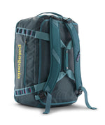 A close up of the Patagonia black hole 40l duffel bag in tidal teal / luminous pink available at Babipur showing the shoulder straps and carry straps detail