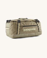Patagonia black hole 40l duffel bag in light green with black zip details and cream printed logo on front panel