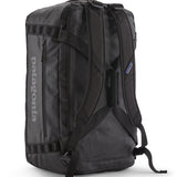A close up of the Patagonia black hole 55L duffel bag in black on black available at Babipur showing the shoulder straps and carry straps detail
