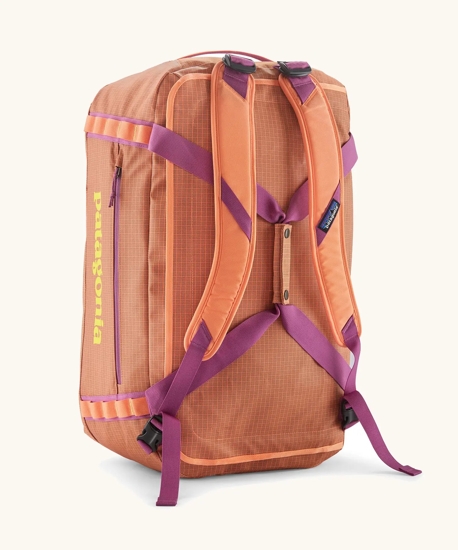 Back of Patagonia black hole 55l duffel bag in bright orange with matching shoulder straps and extra purple carry handles