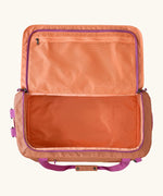 Open Patagonia black hole 55l duffel bag in bright orange showing extra zipped mesh compartments on inside lid