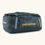 Patagonia black hole 55L duffel bag in dark teal. Features matching zip details, carry straps, extra carry loops and a printed logo on the side
