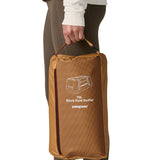 A close up of the carry bag for the Patagonia black hole 55L duffel bag in talon gold available at Babipur. 