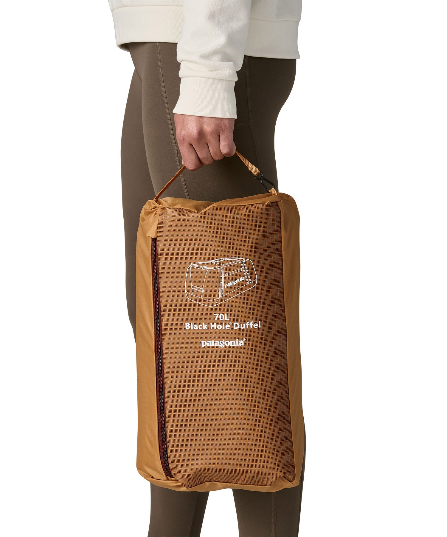 A close up of the carry bag for the Patagonia black hole 55L duffel bag in talon gold available at Babipur. 