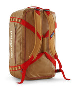 A close up of the Patagonia black hole 55L duffel bag in talon gold available at Babipur showing the shoulder straps and carry straps detail