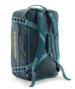 A close up of the Patagonia black hole 55L duffel bag in tidal teal / luminous pink available at Babipur showing the shoulder straps and carry straps detail