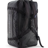 A close up of the Patagonia black hole 70L duffel bag in black on black available at Babipur showing the shoulder straps and carry straps detail