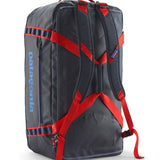 A close up of the Patagonia black hole 70L duffel bag in smolder blue / amanita red  available at Babipur showing the shoulder straps and carry straps detail