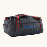 Patagonia black hole 55L duffel bag in Smolder Blue w/ red. Red strap details and blue printed logo. 