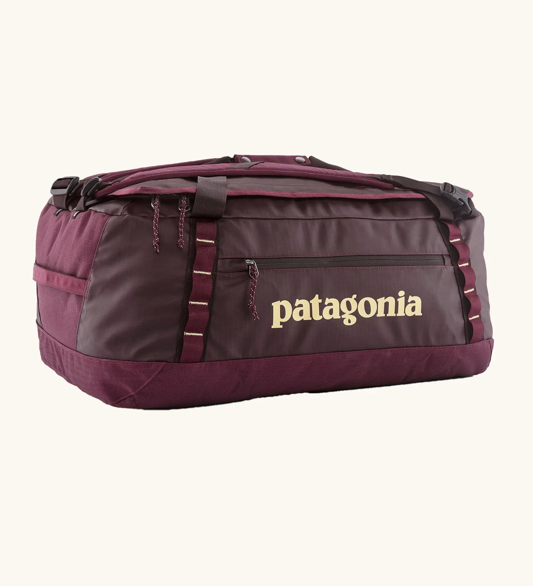 Patagonia black hole 55L duffel bag in Berry Fig with yellow details and Patagonia printed logo.