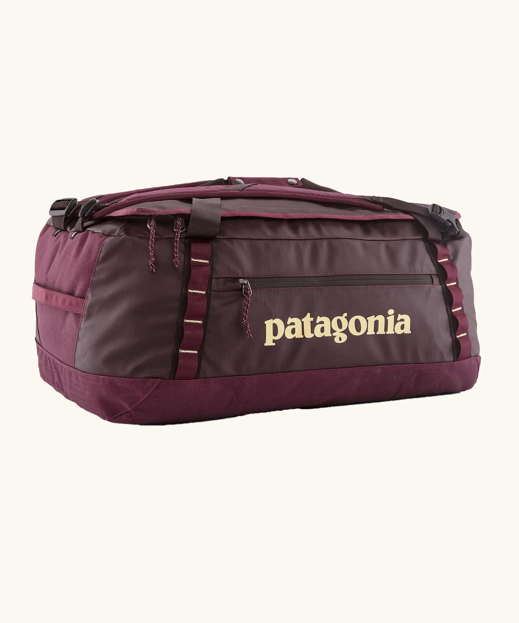 Patagonia black hole 55L duffel bag in Berry Fig with yellow details and Patagonia printed logo.