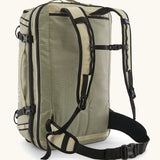 Back of Patagonia 45 litre black hole weather resistant travel backpack in beige showing padded shoulder and hip straps with buckle fasteners