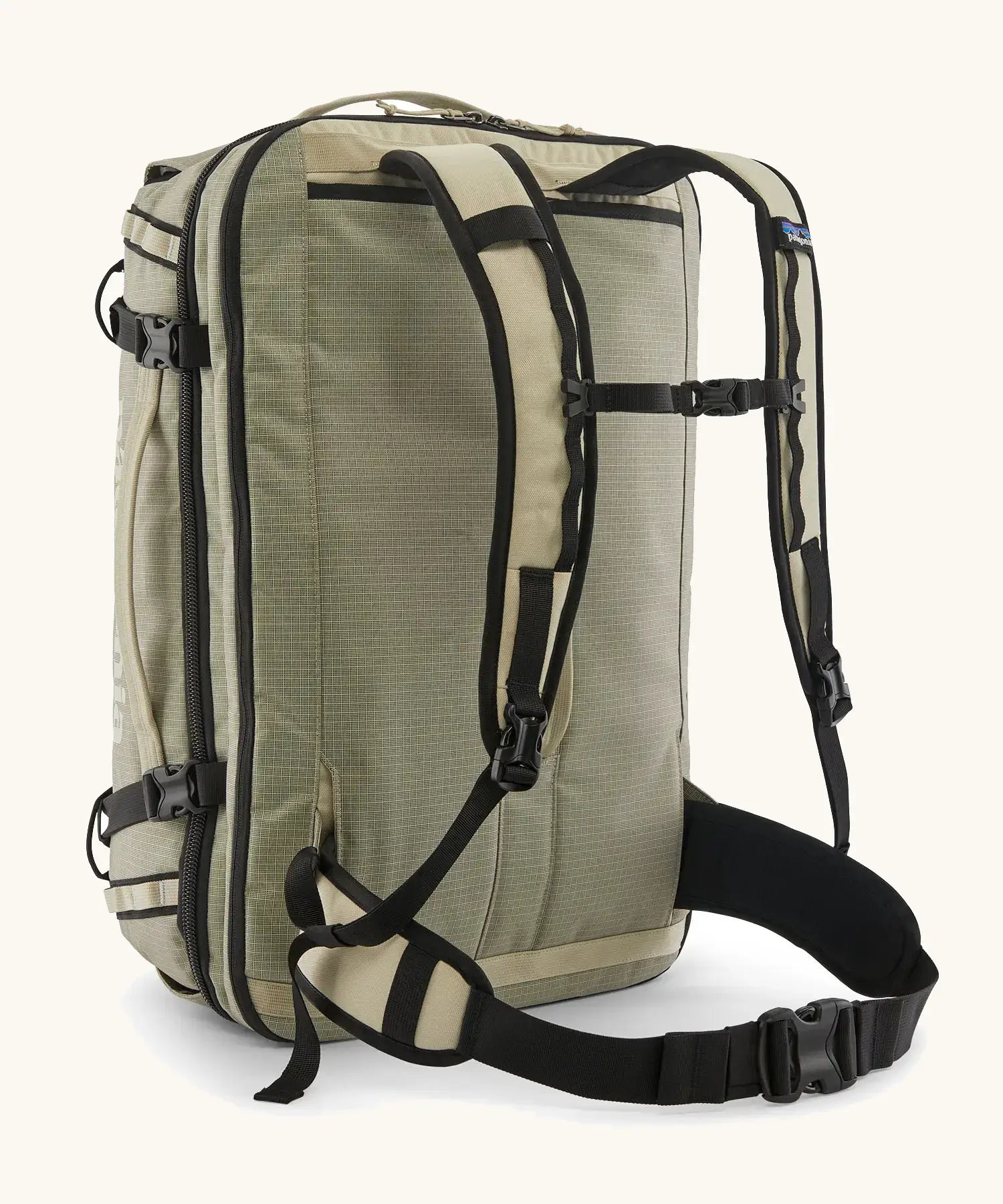 Back of Patagonia 45 litre black hole weather resistant travel backpack in beige showing padded shoulder and hip straps with buckle fasteners